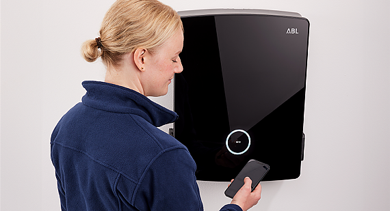 Qualified electrician during commissioning and configuration of an eM4 Twin wallbox with the ABL Configuration App